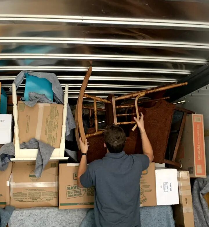 Mover loading furniture into a truck